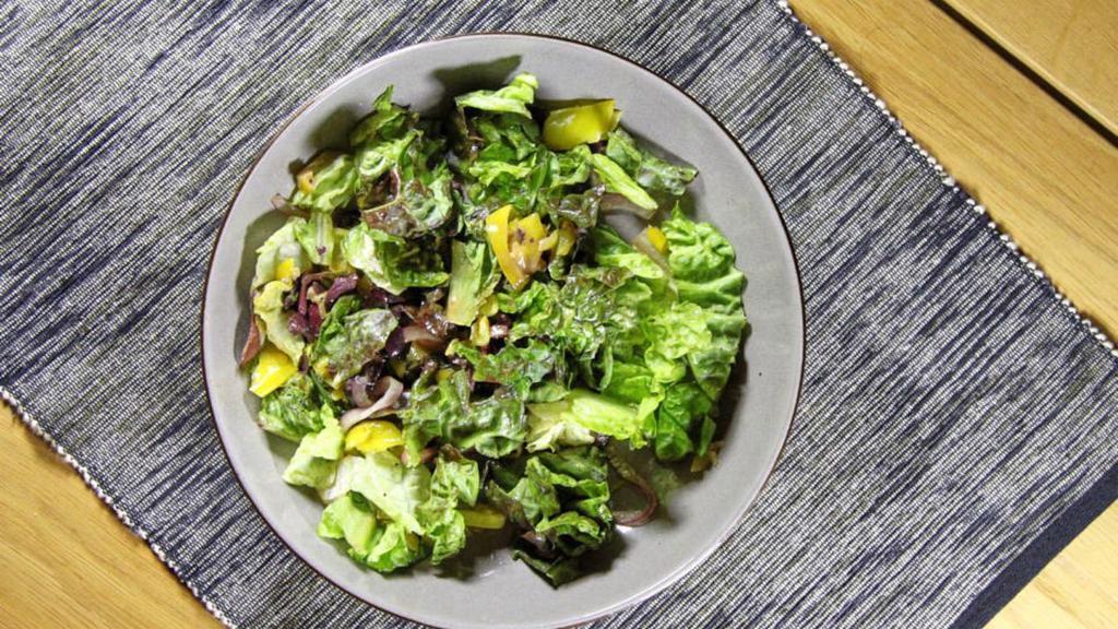 Greek Salad · Lettuce, tomatoes, cucumbers, red onions, feta, kalamata olives, Santorini peppers, dolmadakia.