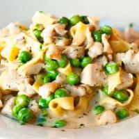 Fettuccine Con Pollo E Piselli · Homemade pasta with chicken and green peas in cream sauce.