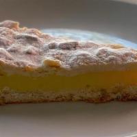 Torta Della Nonna · Short pastry filled with lemon-flavored custard cream and topped with pine nuts and almonds.