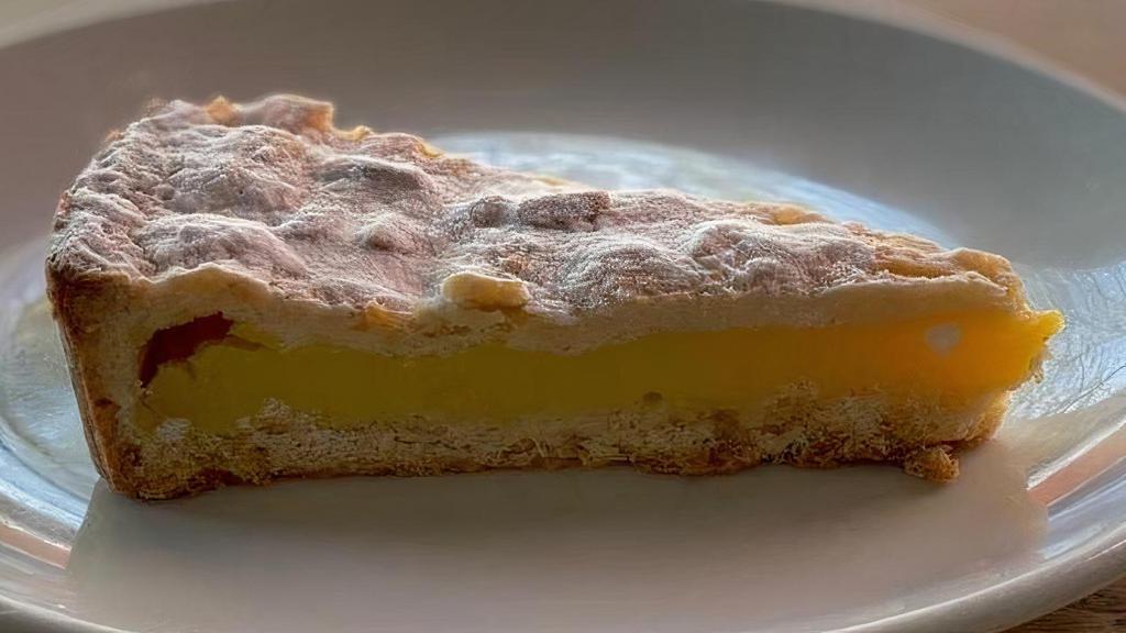 Torta Della Nonna · Short pastry filled with lemon-flavored custard cream and topped with pine nuts and almonds.