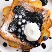 Blueberry French Toast · Warm french toast hot off the griddle, fresh blueberries, dusted with powdered sugar and ser...