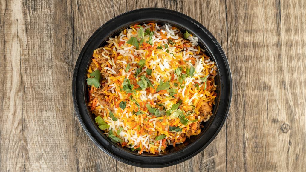 Chicken Biryani · Basmati rice with chicken cooked in herbs & Indian spices.