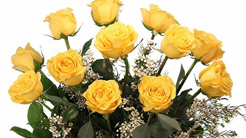 Dozen Yellow Roses Flower Arrangement · These roses will light up any room! Our dozen yellow roses arrangement is bursting with light, love, and sunshine. Inspiring and majestic, everyone who sees this sunny bouquet will feel brighter and sunny. It's sure to bring a smile to anyone's face! Includes clear gathering vase, greens, salal, seeded eucalyptus, flowers: yellow roses, and white waxflower.