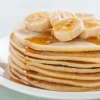Banana Pancakes · Fresh buttermilk pancakes with bananas topped with syrup.