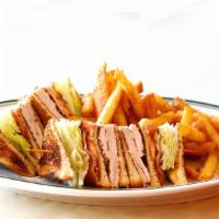 Fresh Turkey Club Sandwich · With bacon lettuce tomato and mayonnaise. served with french fries and cole slaw.
