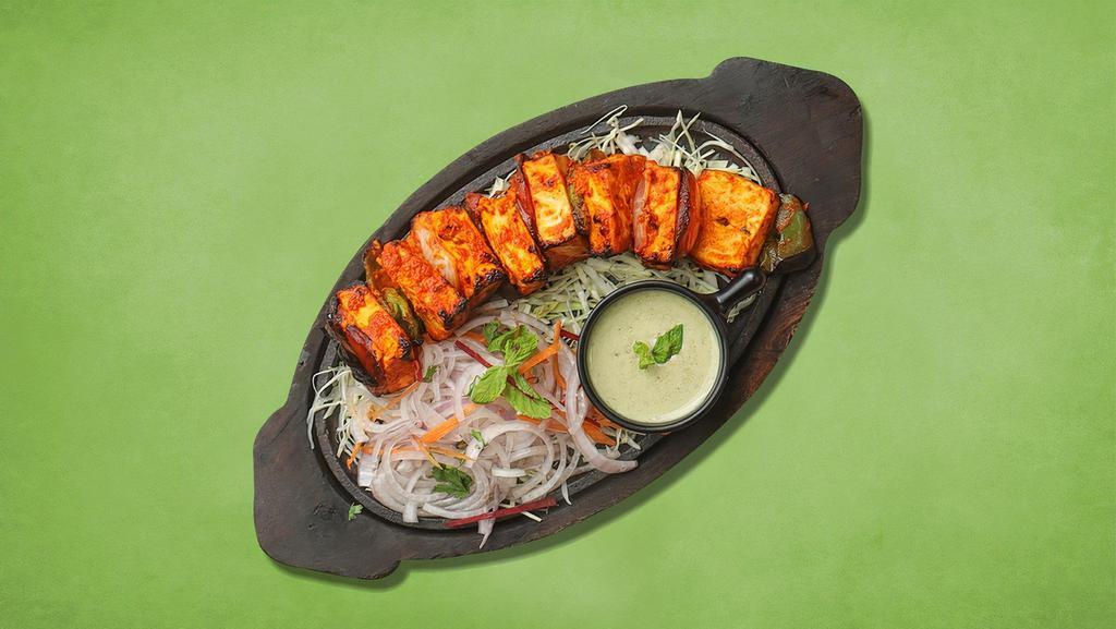 Cottage Cheese Tikka · Homemade cottage cheese cubes marinated in yogurt and spices  cooked in clay oven with bell peppers and onion.