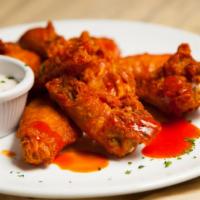 Buffalo Wings · 8 bone-in chicken wings tossed in buffalo sauce with a side of blue cheese.