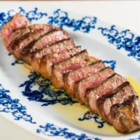 Tagliata Di Manzo* · grass-fed 16 oz. farm New York prime steak, tender green and red oak lettuce, organic red wi...