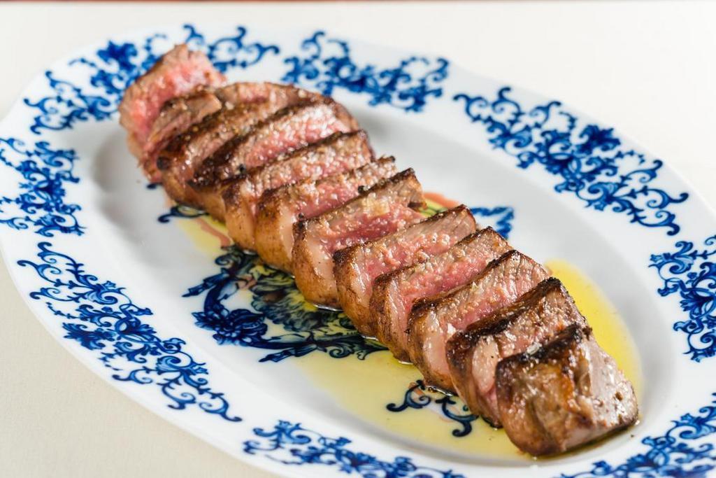 Tagliata Di Manzo* · grass-fed 16 oz. farm New York prime steak, tender green and red oak lettuce, organic red wine vinaigrette.  *Consuming raw or undercooked meats, poultry, seafood, shellfish or eggs may increase your risk of food borne illness