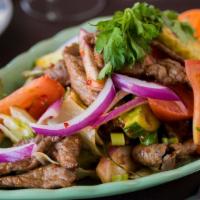 Charbroiled Beef Salad · Marinated thin sliced skirt steak with fresh scallion, red onion, and chili lime
juice dress...