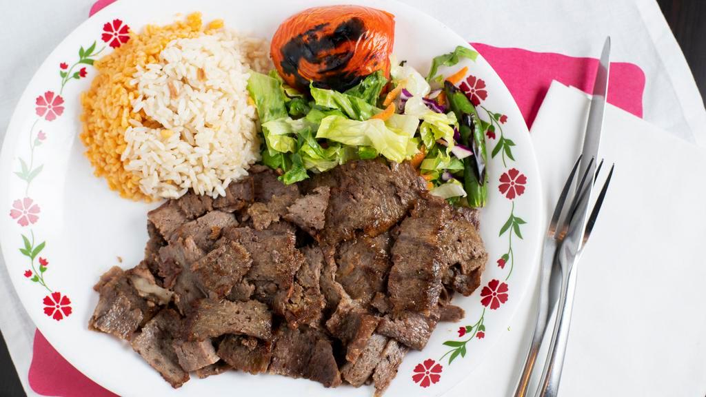 Gyro Kebab · Lamb and beef cooked on a bed of special spicy sauce.