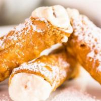 Cannoli · Cream filled Italian pastry dusted with powdered sugar.