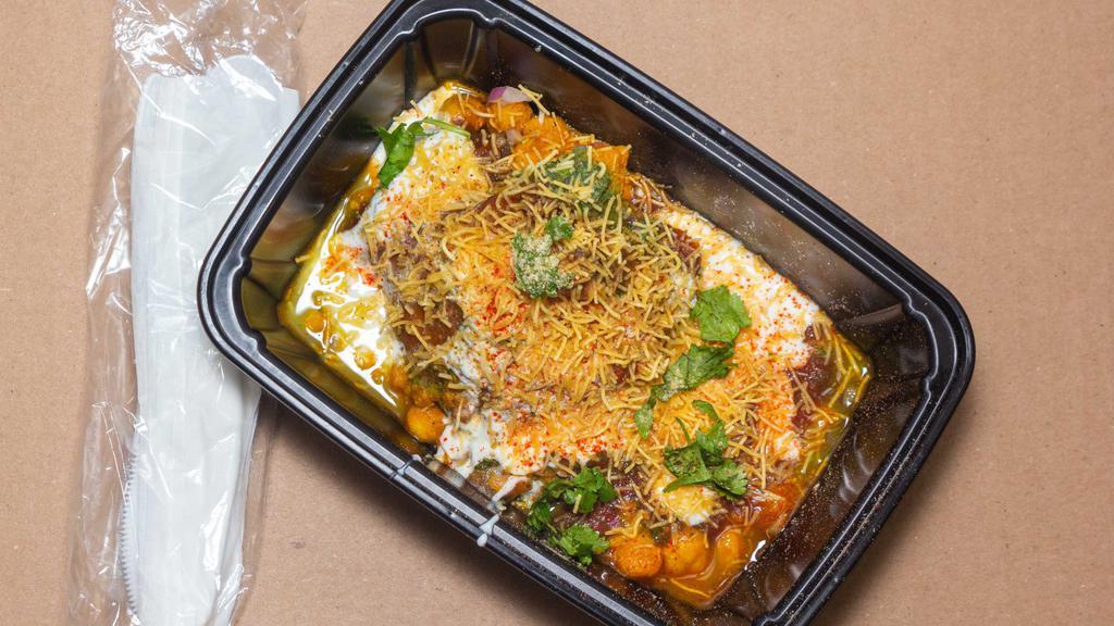 Samosa Chaat · Homemade pastry stuffed with sautéed potatoes and peas topped with spices, yogurt, and chutney.