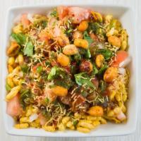 Bhel Puri · Crispy rice puffs topped with onions, potatoes, coriander, and chutney.