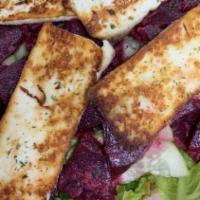 Halloumi Beet · Greens, tomatoes, cucumbers, beets and mixed herbs, topped with grilled halloumi cheese.