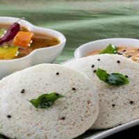 Idli / Medu Vada · Steamed rice and lentil patties served with chutney and sambar / crispy lentil doughnut serv...