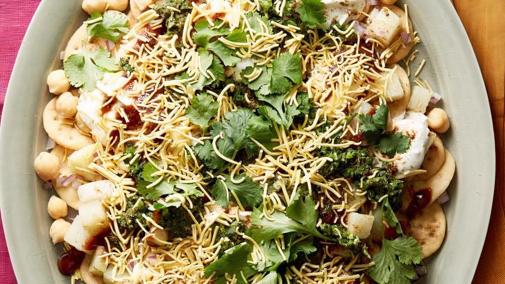 Aloo Papdi Chaat · Crisp fried dough wafers known as papdi along with boiled chick peas, boiled potatoes, yogurt & tamrind chutney.