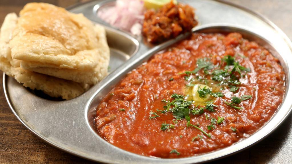 Pav Bhaji · Pav bhaji is a spicy blend of vegetables in tomato gravy served with pav (buttered buns). (Spicy).