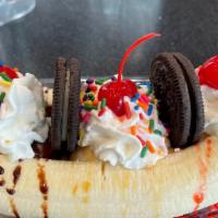 Banana Split · 3 scoops of your favorite ice cream flavors, banana, hot fudge, caramel strawberry syrup, wh...