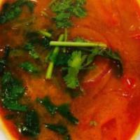Tom Yum Seafood Soup · Hot and spicy.Shrimp, scallops, squid, fish cake, peppers, tomato, and cilantro.