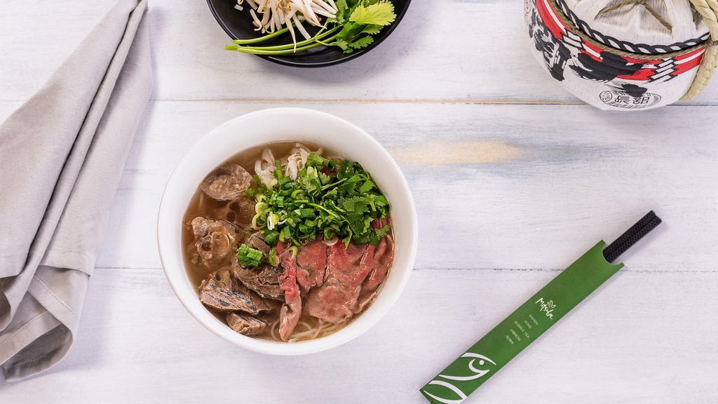 Pho · Tai-rare beef slices “classic”, beef tripe, beef tendon, cilantro, rice noodle, green onion, onions, bean sprouts, and lime. Add ramen noodle, udon noodle, rice noodle, egg, chashu (roasted pork belly), braised beef for an additional charge.
