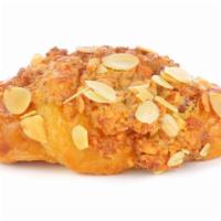 Almond Croissant · Crispy, soft flaky pastry with almonds.