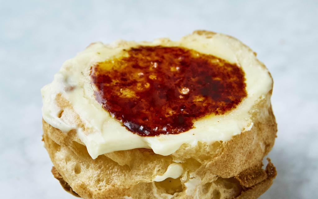 Crème Brûlée · Rich custard base topped with a texturally contrasting layer of hardened caramelized sugar, in a puff.