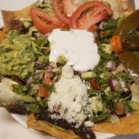 Fried Pork Nachos · Corn tortilla Chips, beans, melted cheese, sour cream lettuce, tomatoes, jalapeños and guaca...