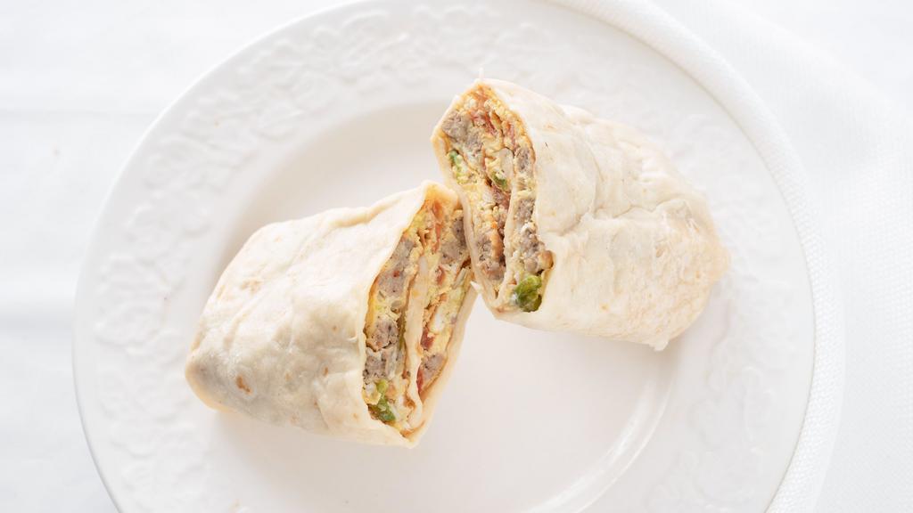 Breakfast Burrito With Sausage · Fresh chopped onions, green peppers, tomatoes, srambled eggs, sausage, and cheese wrapped in a large tortilla.
