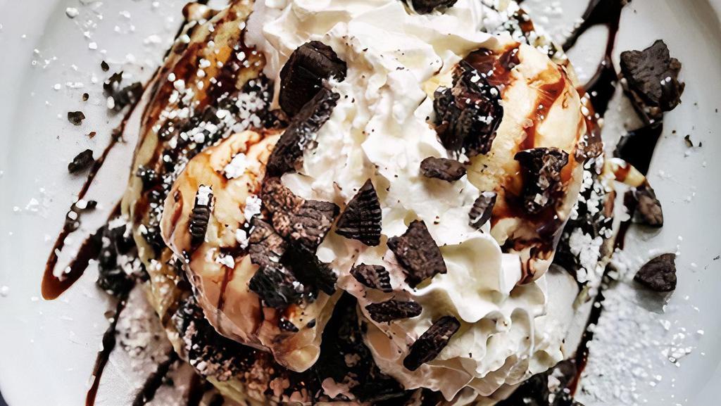 Oreo Cookie Pancakes · Buttermilks baked with oreo cookies inside and topped with oreo cookies, vanilla ice cream, chocolate sauce, and whipped cream.