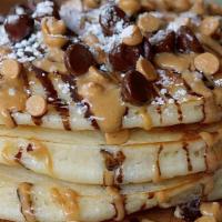 Chocolate & Peanut Butter Pancakes · Baked with peanut butter chips and chocolate chips, topped with whipped cream, peanut butter...