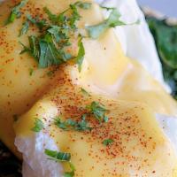 Eggs Florentine · Toasted pita topped with poached eggs, fresh spinach and imported feta cheese, drizzled with...