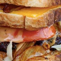 Man Vs Burger · Two grilled American cheese sandwiches with our burger, bacon, caramelized onions, lettuce, ...