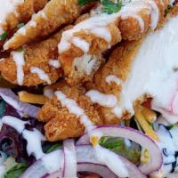 Southwest Chicken Salad · Crispy fried chicken tender strips, jalapenos, cucumbers, tomato, red onions, sweet corn, av...