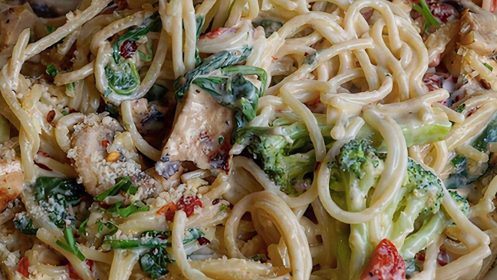 Rasta Pasta · Grilled chicken, broccoli, red pepper flakes, spinach, roasted red peppers and mushrooms over spaghetti in a spicy creamy alfredo sauce. Served with a cup of soup or house salad, and bread.