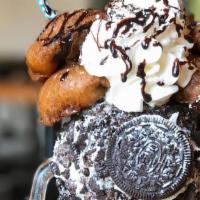 Fried Oreo Cookie Shake · Our oreo cookie shake in an oreo crumb decorated glass, topped with whipped cream, fried ore...