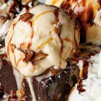 Turtle Brownie Sundae · Fudgy brownie topped with vanilla ice cream, chocolate sauce, pecans and whipped cream.
