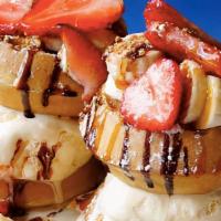 Mini Waffle Tower · Mini waffles with vanilla ice cream, banana, strawberries, caramel sauce, chocolate sauce & ...