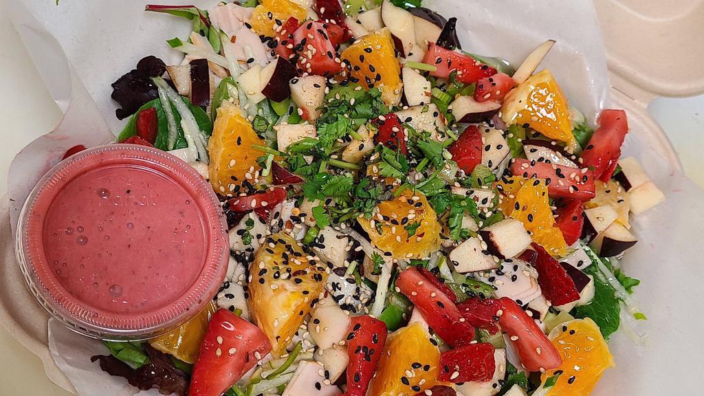 Farm Gone Wild · Mixed greens tossed with smoked turkey, apple, celery, cucumber and house-made raspberry vinaigrette dressing. Topped with bacon, orange, strawberry, sesame seeds, chili flakes, cilantro and honey drizzle.