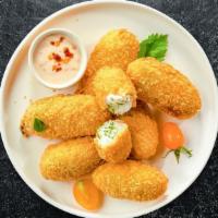 Hot Shot Poppers · Fresh jalapenos coated in cream cheese and fried until golden brown. Served with jalapeno ra...