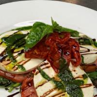 Mozzarella Caprese · Fresh mozzarella, tomatoes, roasted peppers, fresh basil drizzled with oil and balsamic redu...