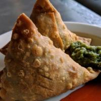 Samosa · Crispy fried turnovers filled with spiced peas and potatoes.