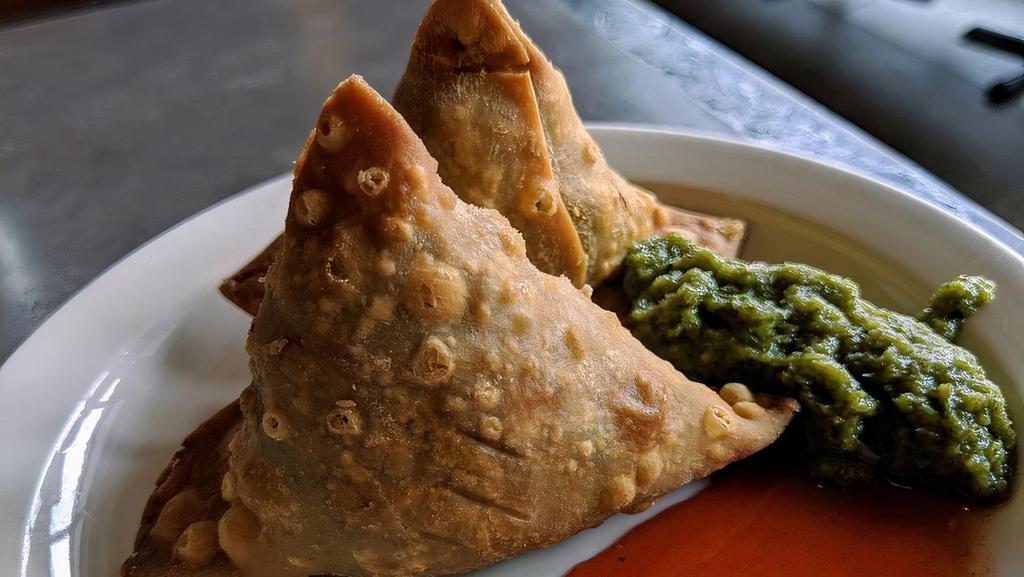 Samosa · Crispy fried turnovers filled with spiced peas and potatoes.
