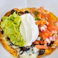 Tortilla Pizza · Crispy flour tortilla topped with melted Jack and Cheddar cheese, sour cream, guacamole, fre...
