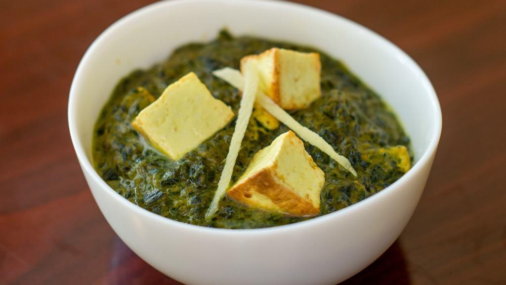 Saag Paneer · Spinach cooked with cheese cubes and seasoned with freshly ground herbs.  Served with basmati rice.