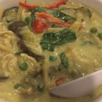 Green Curry · Sliced chicken breast, eggplant, bamboo shoots, lime leaf, peas, & basil in green curry sauc...