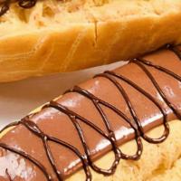 Classic Éclair · Puff pastry filled with vanilla bean custard, topped with chocolate icing and milk chocolate...