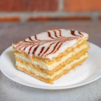 American Napoleon · Layers of mila foglia pastry filled with vanilla bean French cream, topped with vanilla and ...