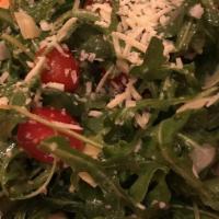 Arugula Salad · Baby arugula salad, shaved Parmigiano, cherry tomato, artichoke. Served with a lemon vinaigr...