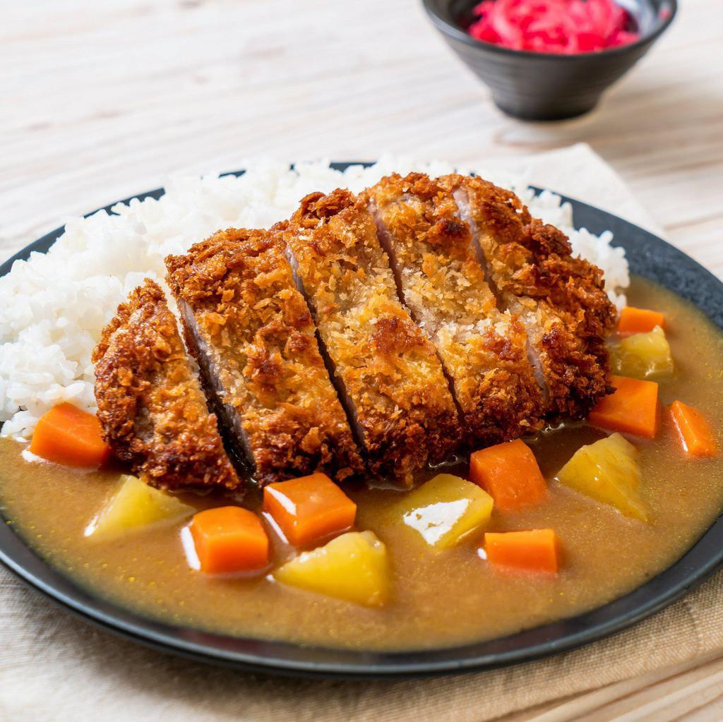 Pork Katsu Curry · Freshly battered pork with panko fried to a crisp perfection served with curry, cabbage, and red pickles.